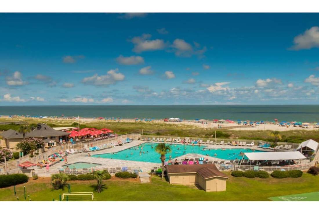 The resort's large beachside pool beside the dunes and ocean
