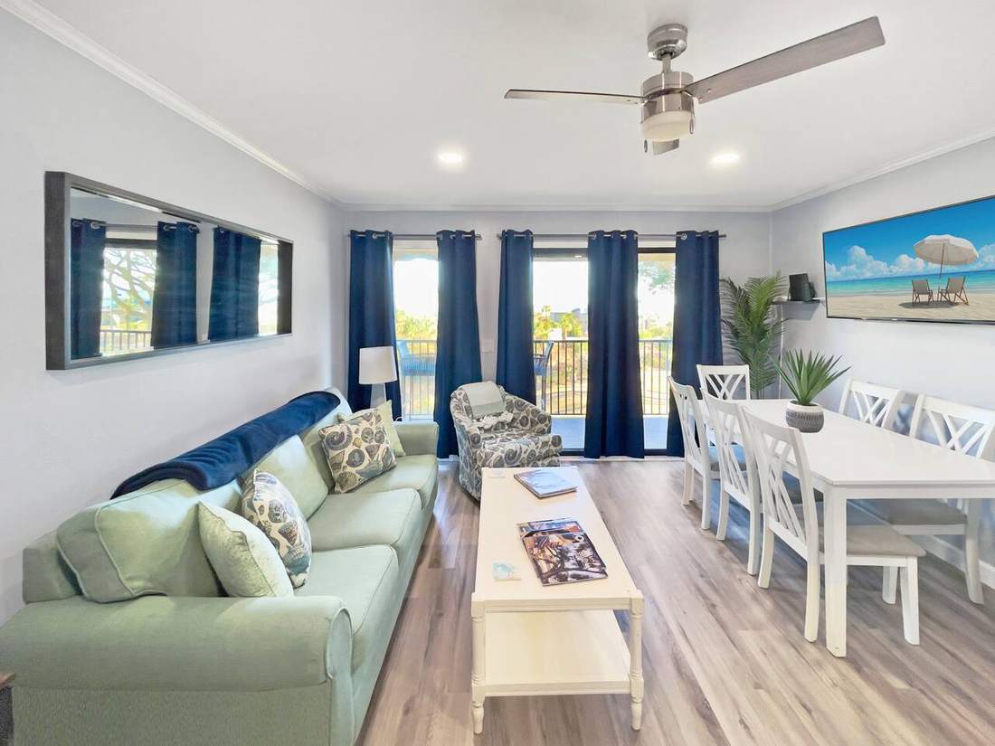 Living room with sofa, 55-inch TV and sliding doors to the balcony