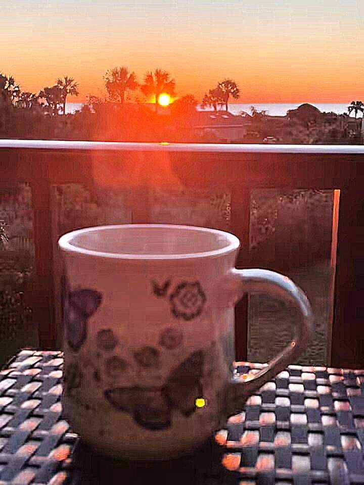 Morning coffee on the balcony as the sun rises over the Atlantic